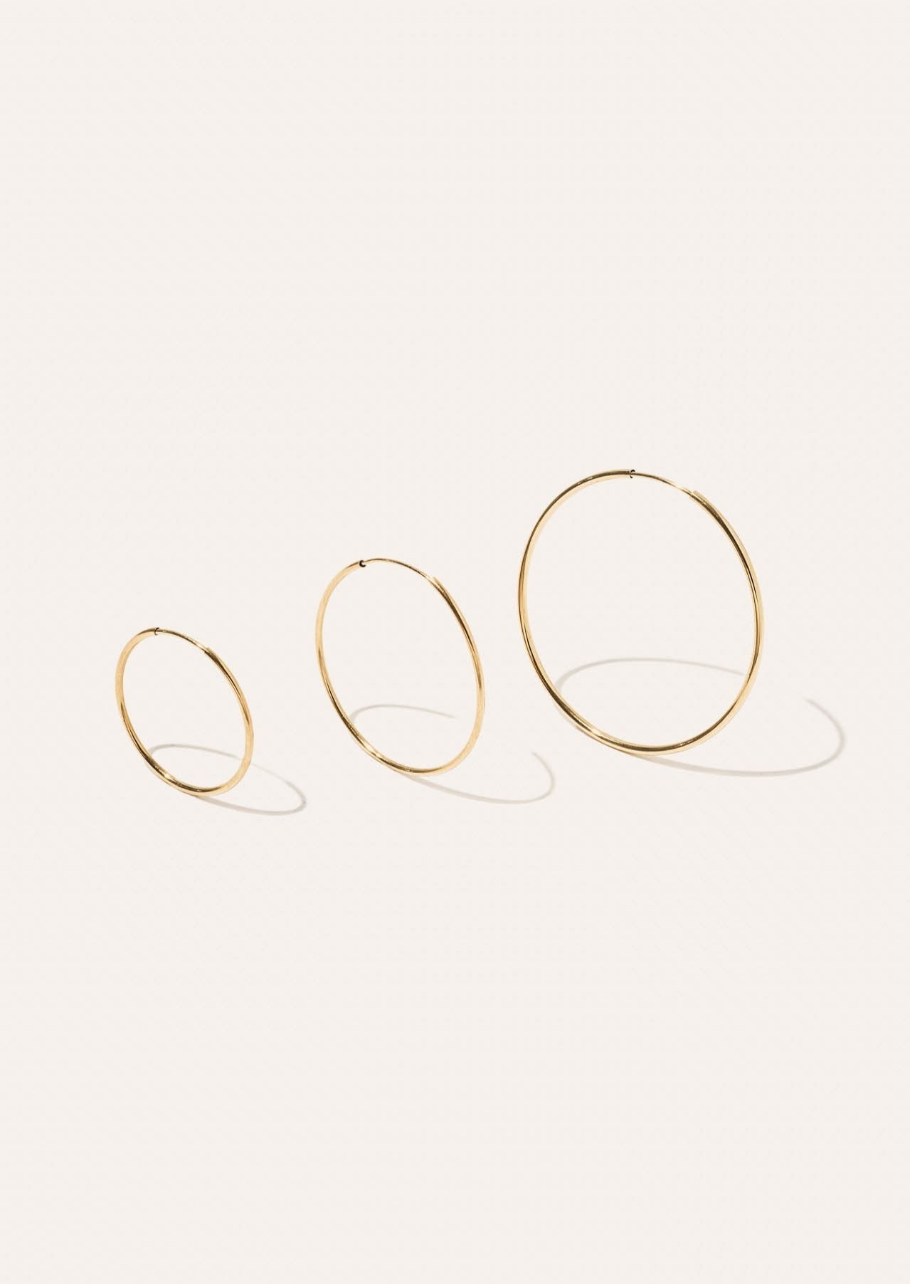 alt="Lightweight Hoop Earrings - Medium compared to the small and large"