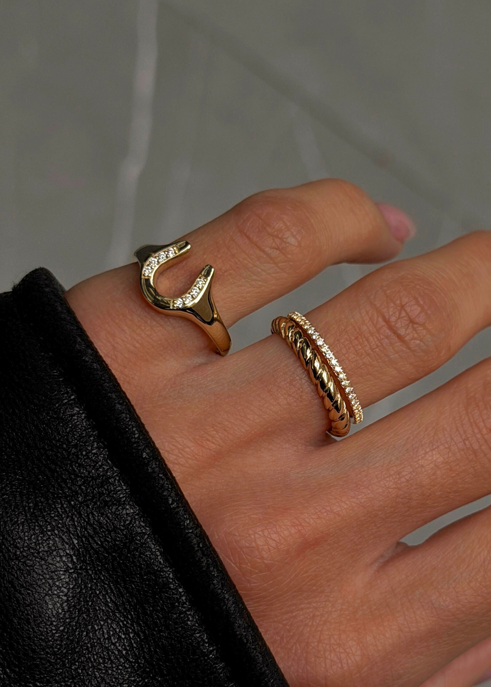 Kinn Studio 14k Gold Horseshoe Diamond Signet Ring on a pinky finger