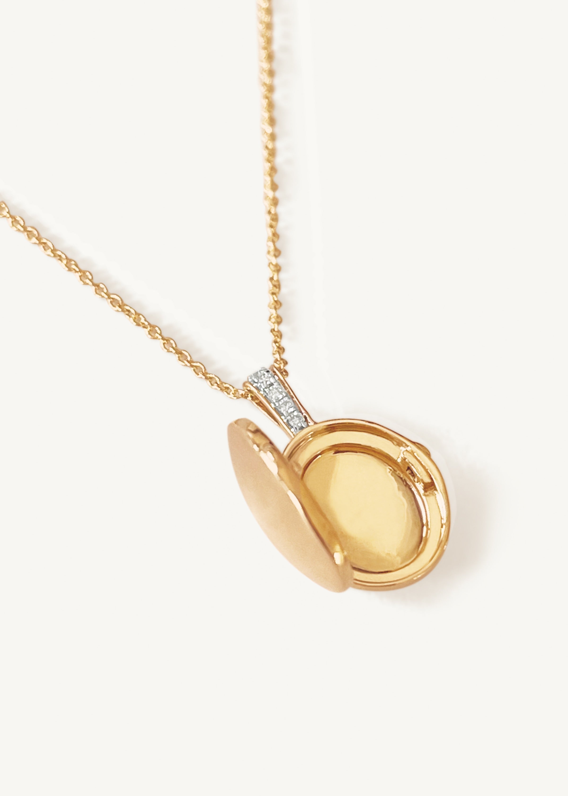 alt="Maison Oval Locket II opened with micro rolo chain necklace"