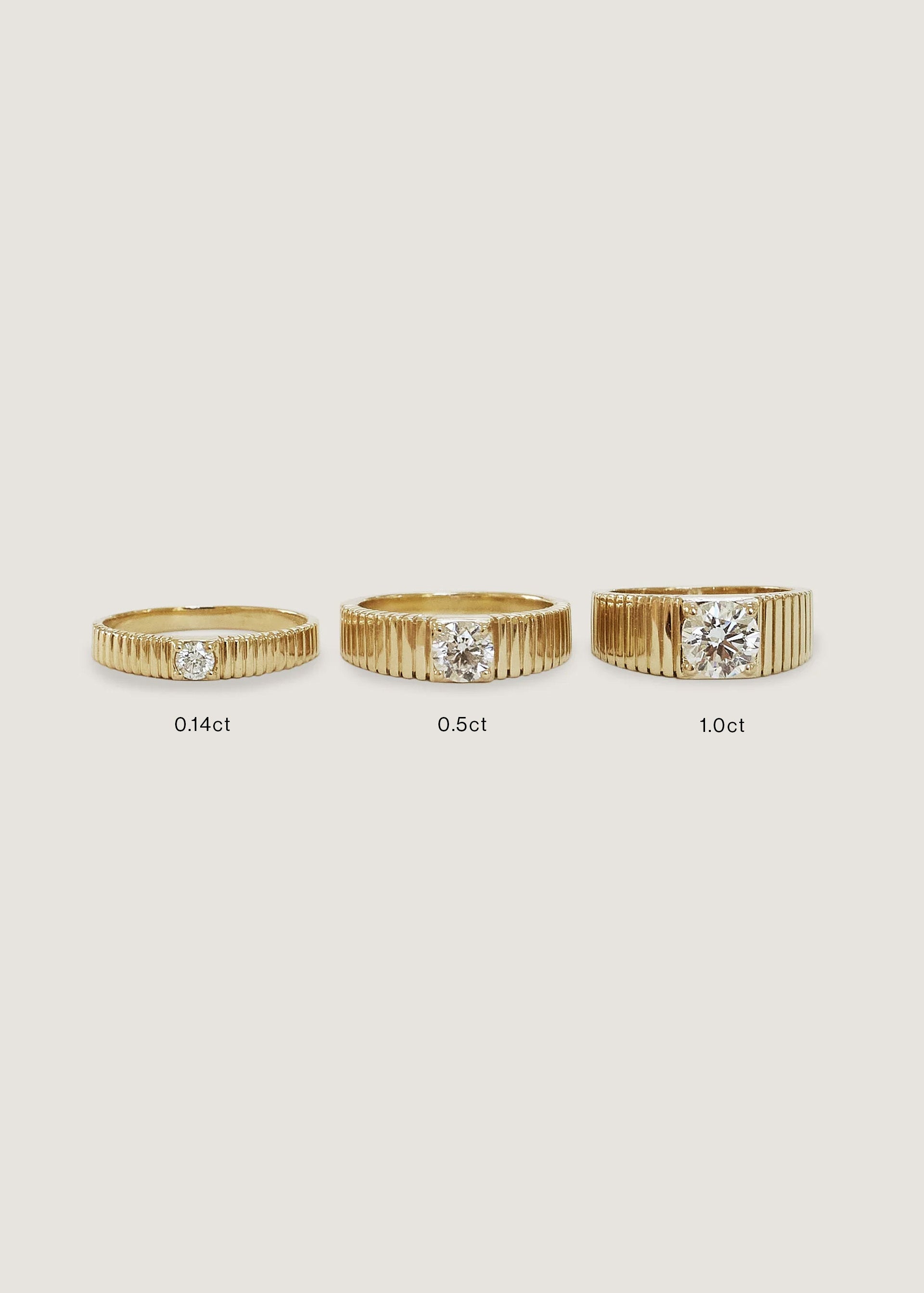 Side by side comparison of 3 different sizes of the Kinn 14k Gold Solis Round Diamond Ribbed Band Ring.  Comes in Petite (0.14ct), 0.5 ct, and 1.0 ct diamond sizes.