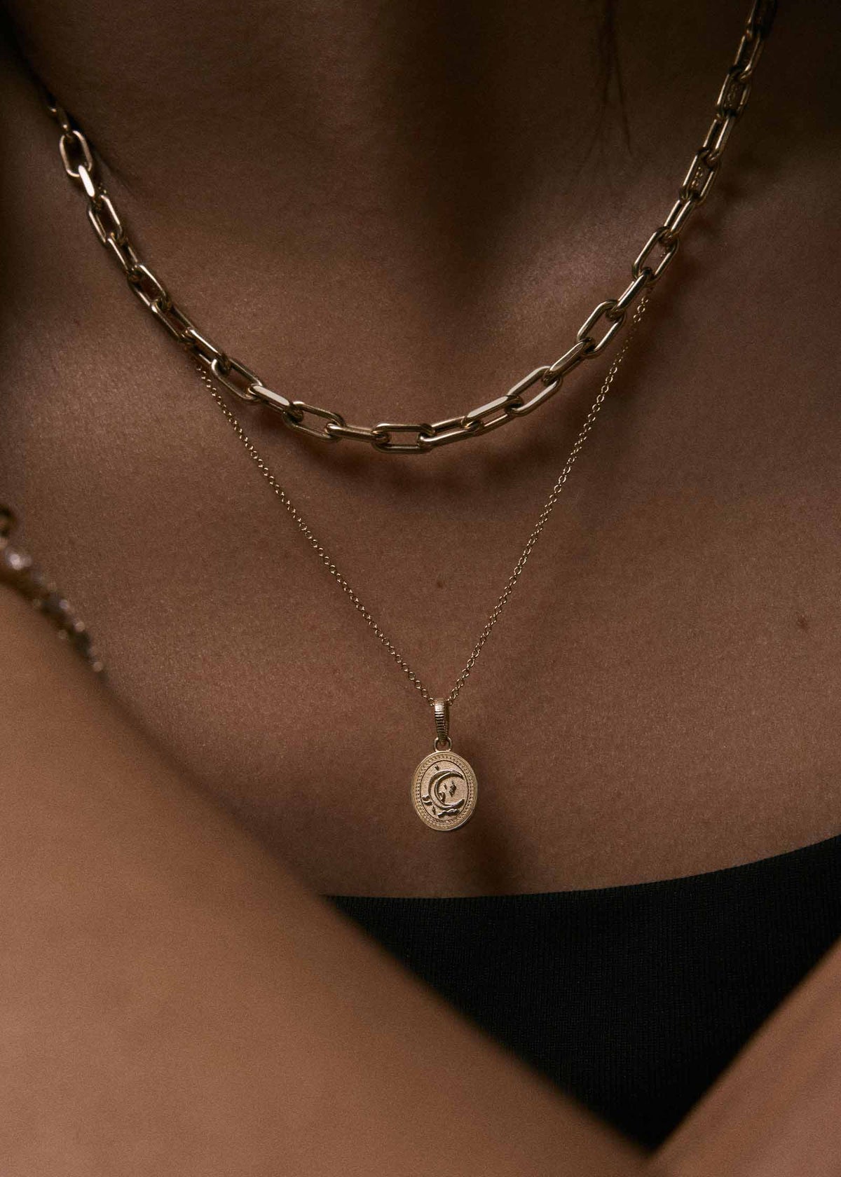 close up of a woman wearing a Kinn 14k Gold Crescent Dream Pendant Micro Rolo Chain Necklace