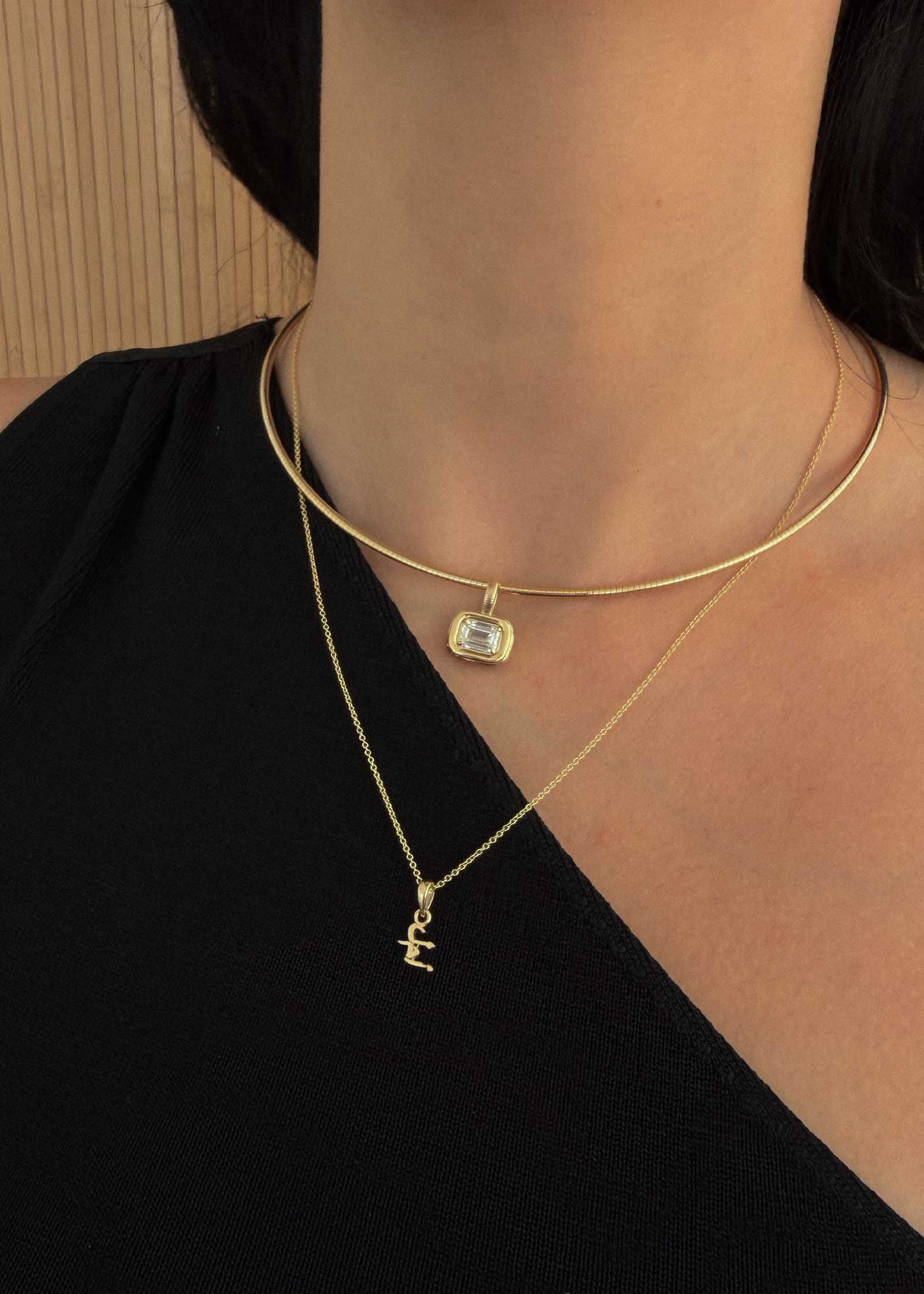 woman wearing a Kinn 14k Gold Dear Kaia Vertical Pendant Necklace in Arabic