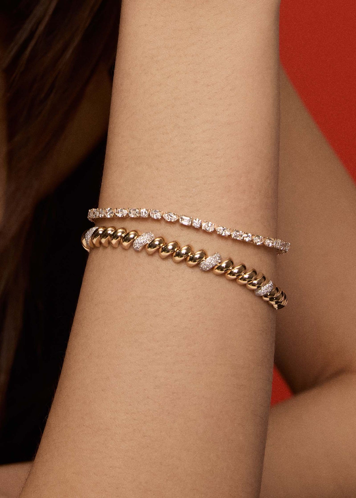 close up of a woman's arm wearing a Kinn 14k Gold Pavé Diamond Petite Hampshire House Bracelet stacked with an Esme Diamond Tennis Bracelet