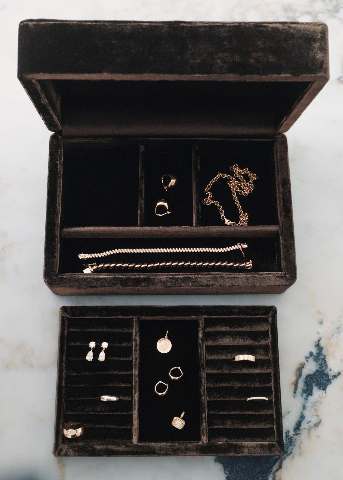 An open Kinn Studio The Keepsake Jewelry Box in brown velvet with the interior tray laying in front and jewelry stored inside