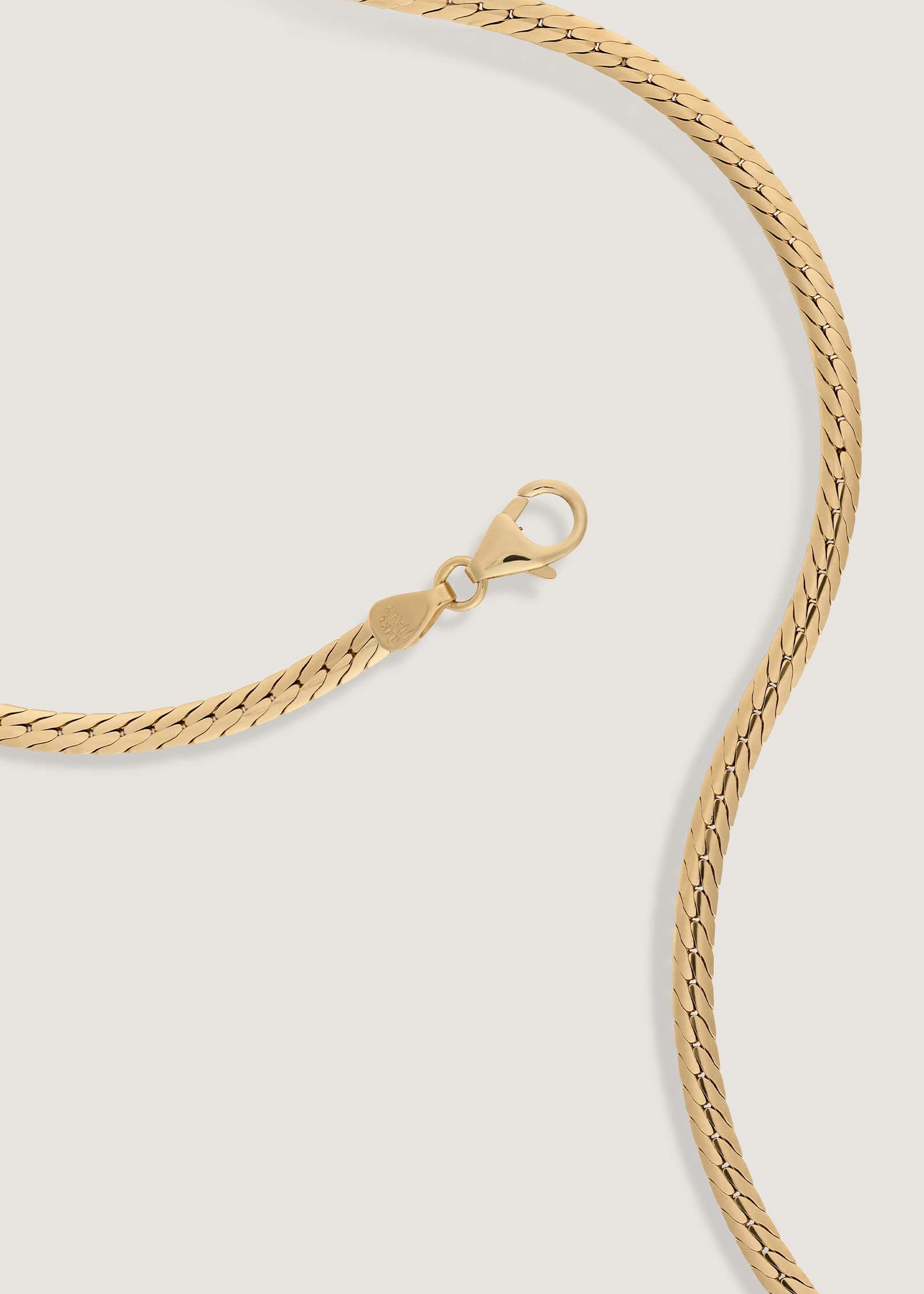 Kinn 14k Gold Kennedy Herringbone Chain Necklace laying flat showing the lobster clasp closure