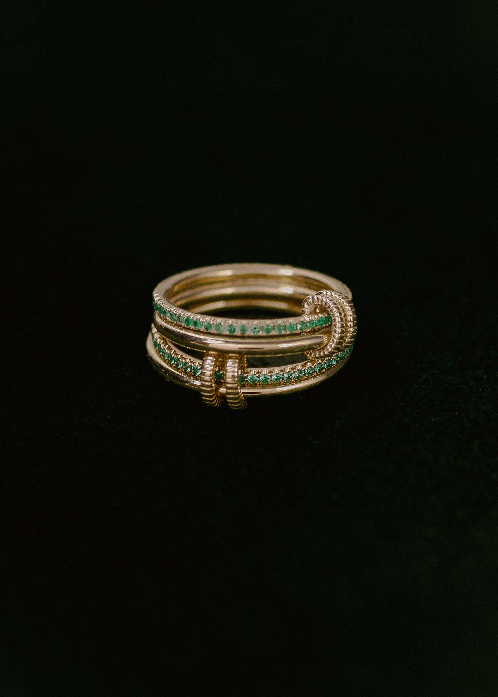 close up of two Kinn x Prince 14k Gold Lesley Linked Emerald Band Rings stacked together