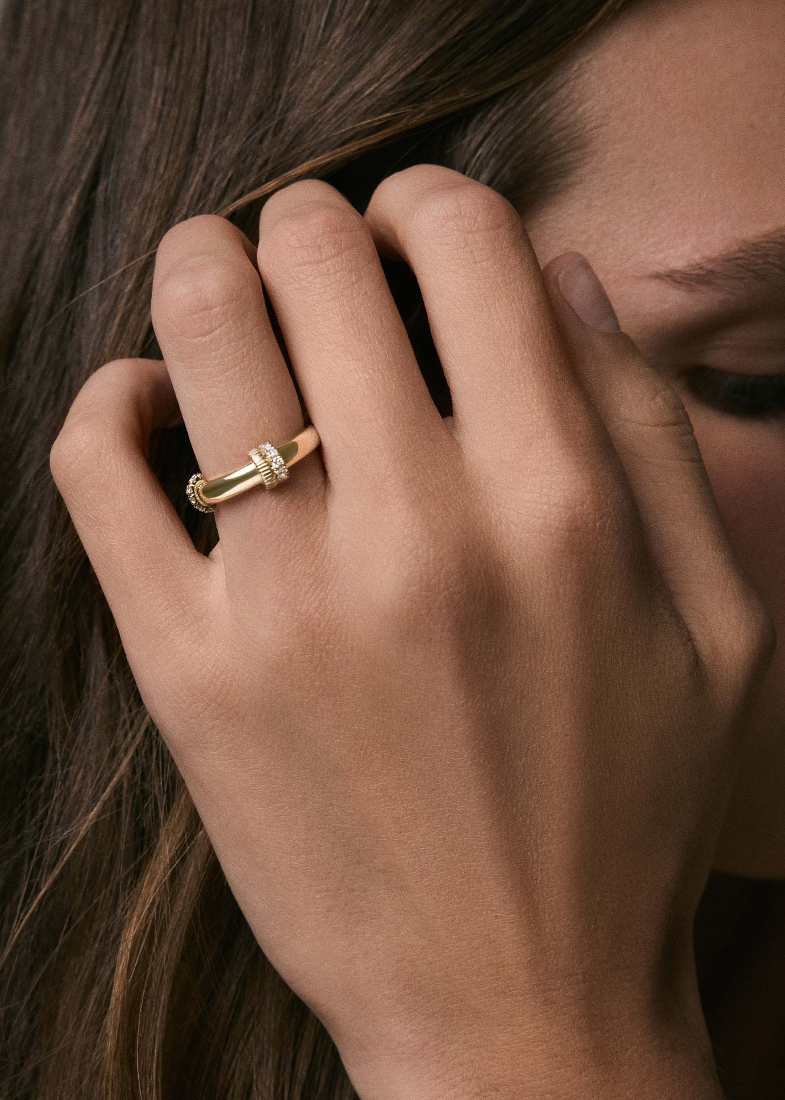 close up of a woman's hand wearing a Kinn x Prince 14k Gold Rally Pavé Diamond Ring