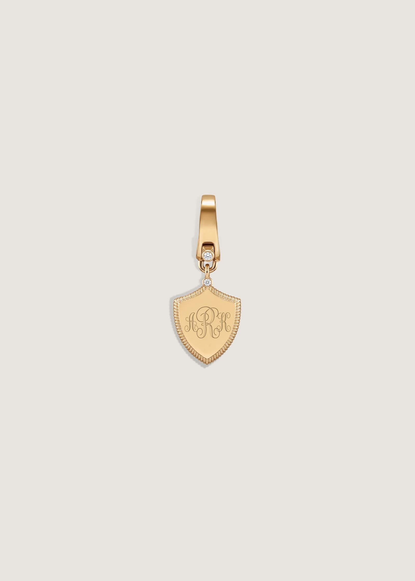 A Kinn 14k Gold Ace Shield Diamond Pendant engraved with a 3 letter monogram