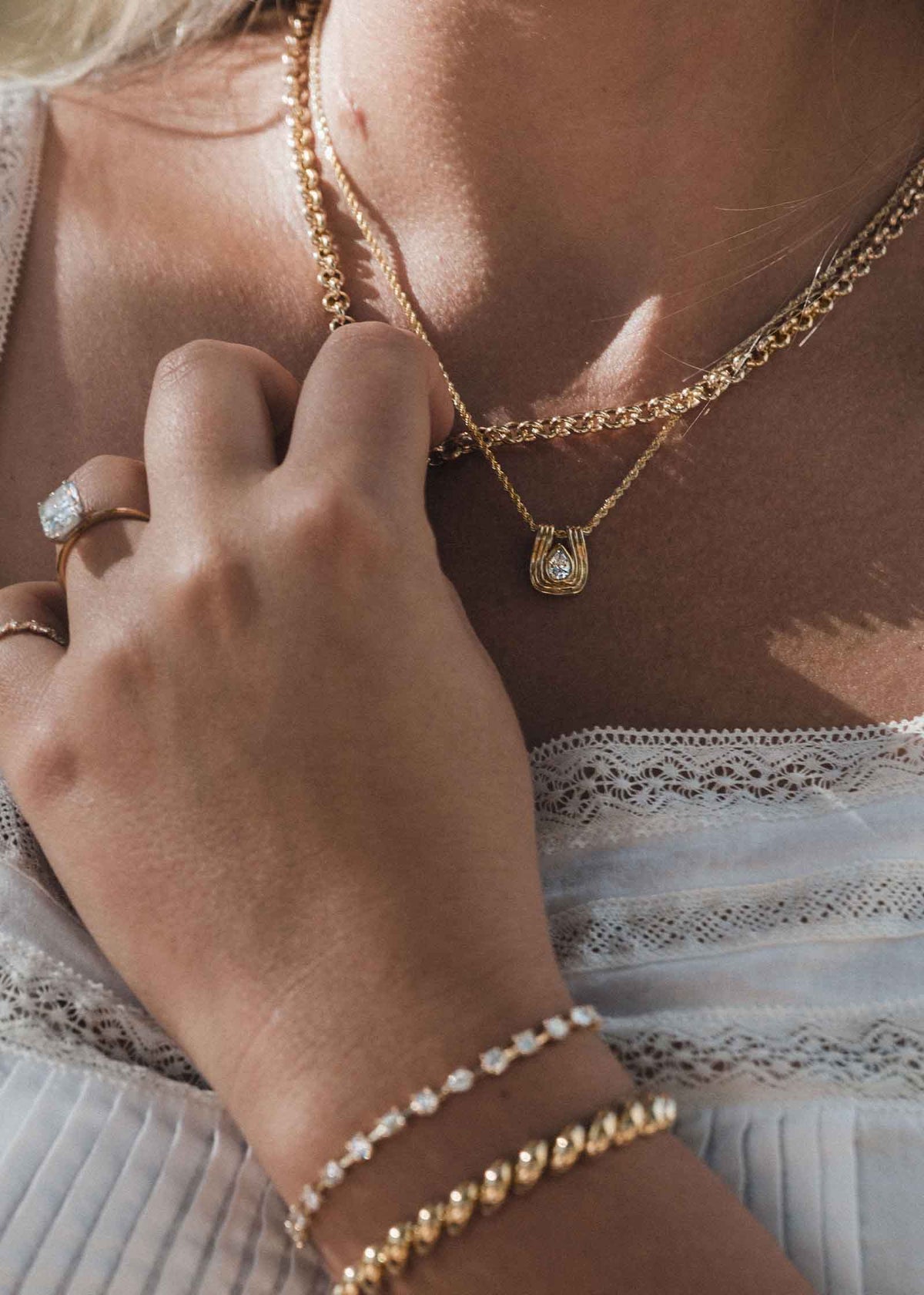 woman wearing a Kinn Studio 14k Gold Alyssa Pear Diamond Pendant on a Petite Rope Chain layered with a Matis Rolo Chain