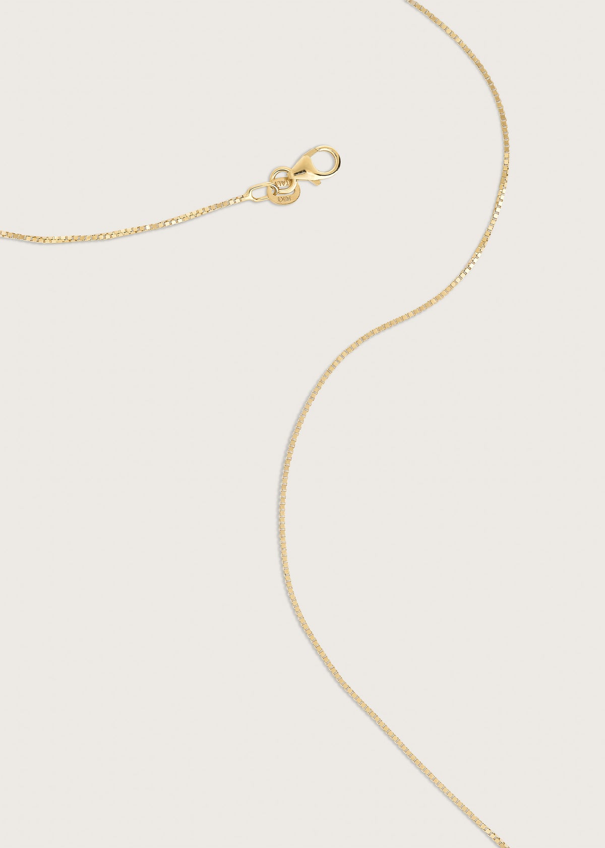 Kinn 14k Gold Box Chain Necklace laying flat showing the clasp closure
