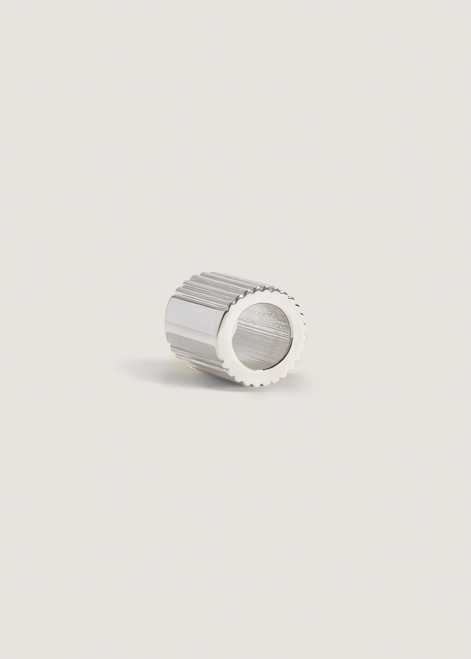 Side angled view of a Kinn x Shoppe Amber Interiors The Estate Charm Sterling Silver