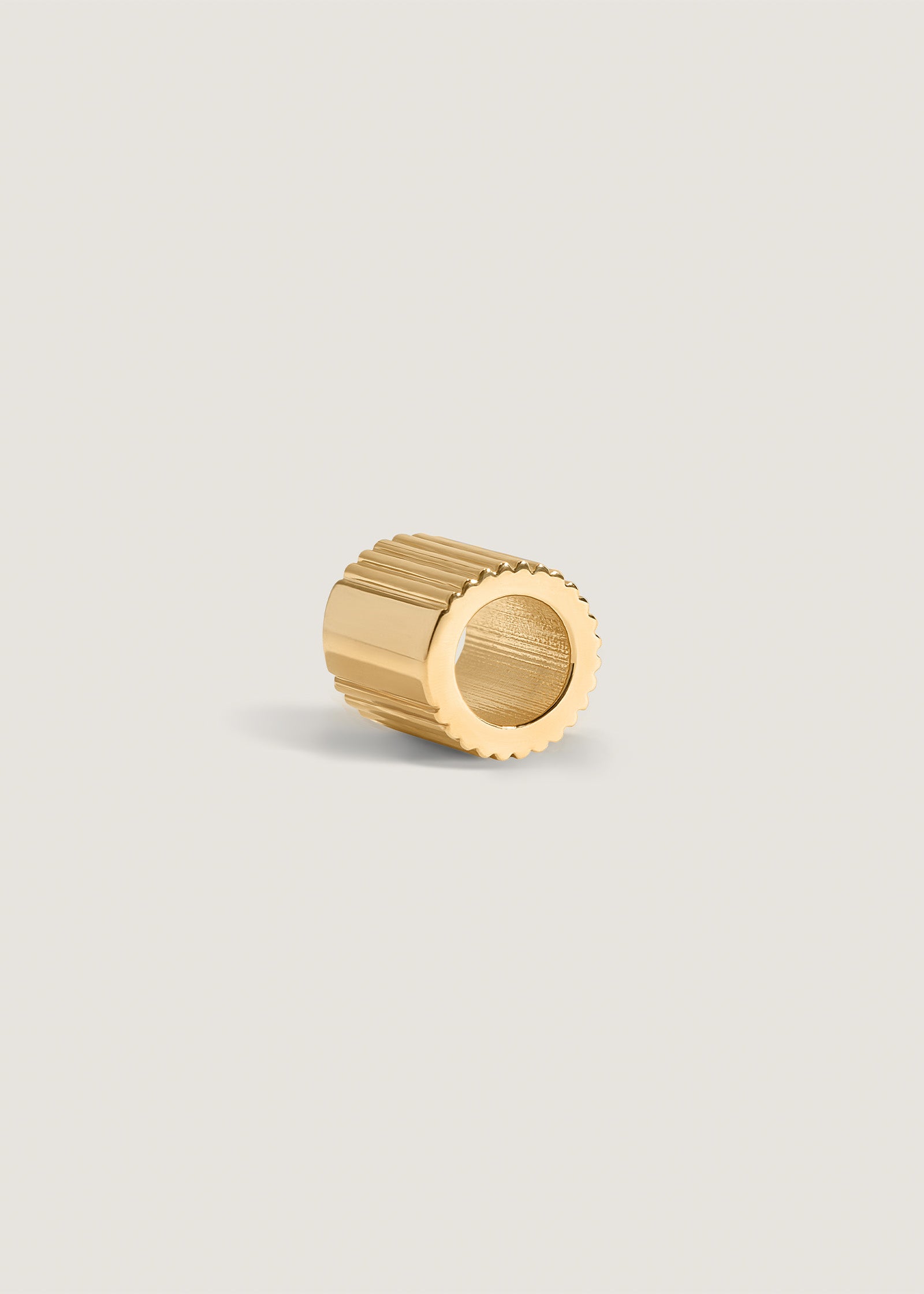 A side angled view of Kinn x Shoppe Amber Interiors The Estate Charm 14k Yellow Gold