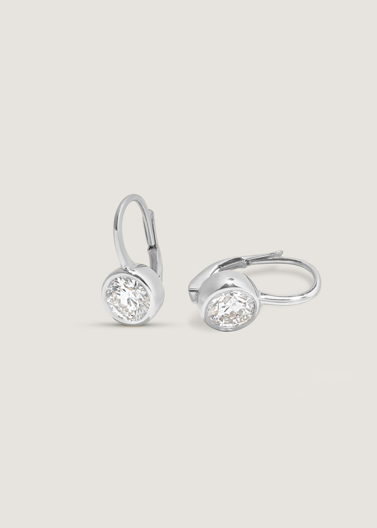 Angled view of a pair of Kinn 14k White Gold Harper 2ctw Round Drop Earrings