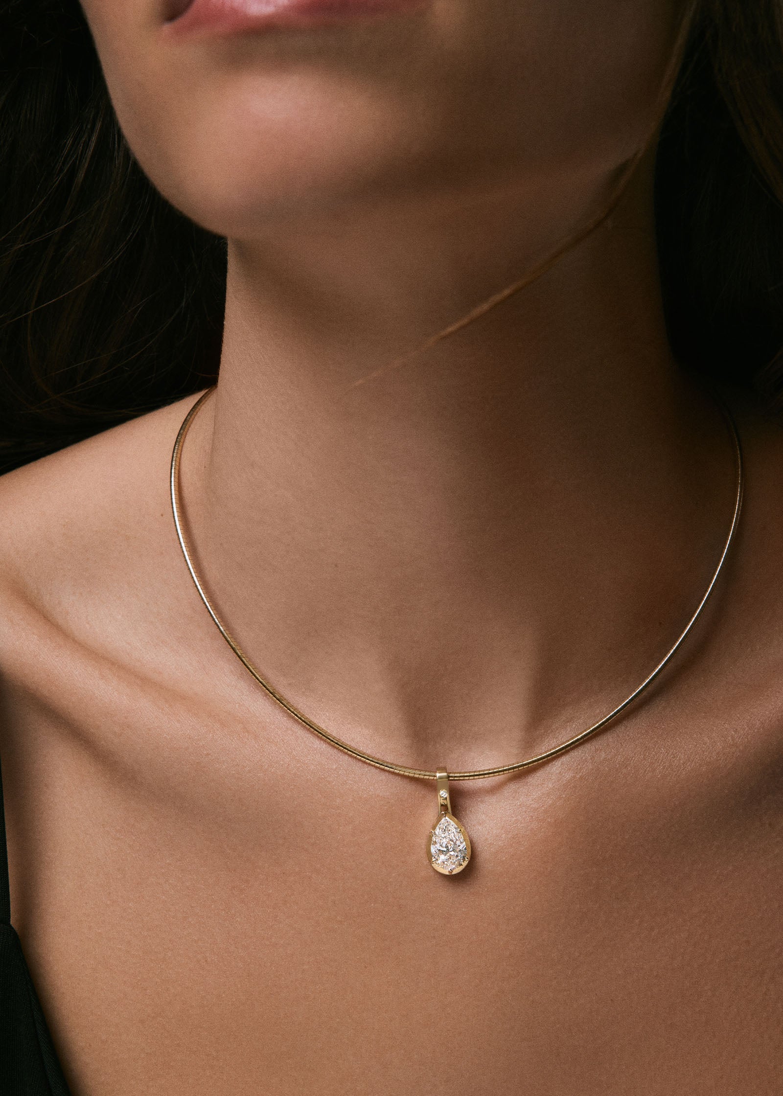 woman wearing a Kinn Studio 14k Gold Heirloom Curved Chain Necklace with a Madeleine Pear Pendant