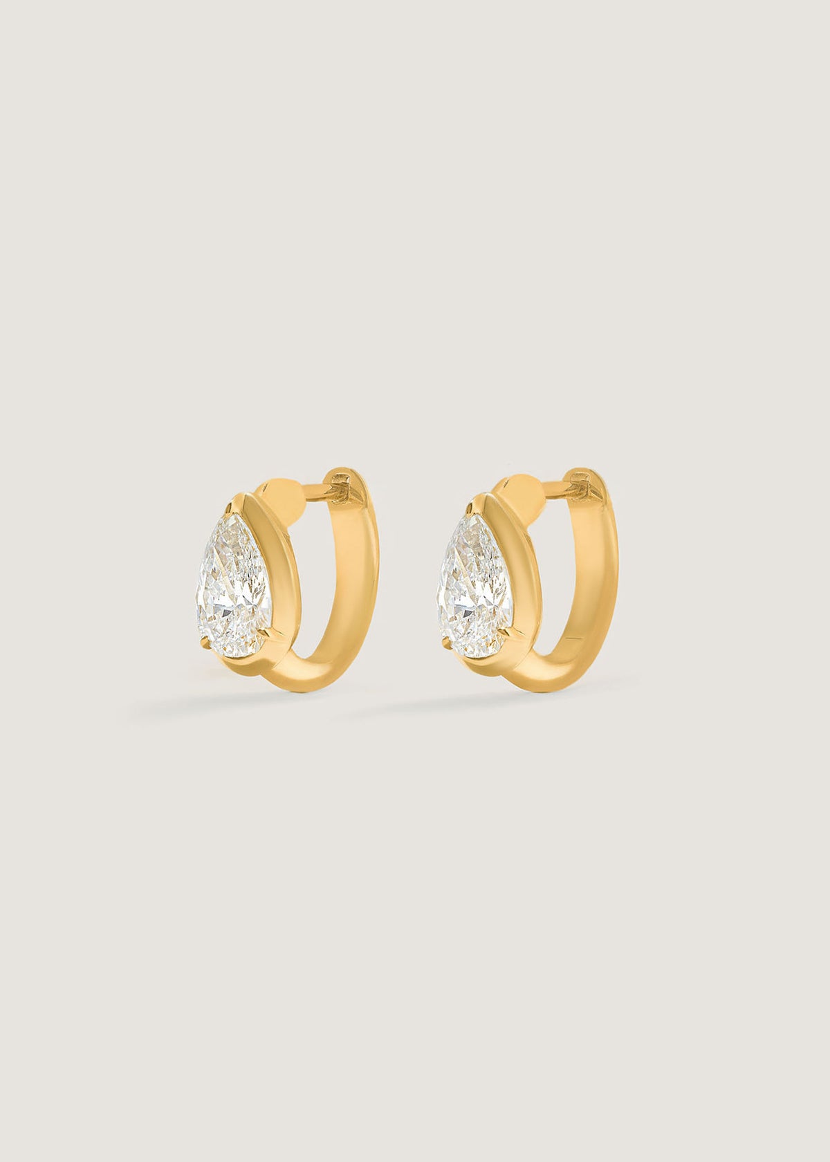 Side angled view of Kinn 14k Gold Jackson Pear Diamond Huggie Hoop Earrings