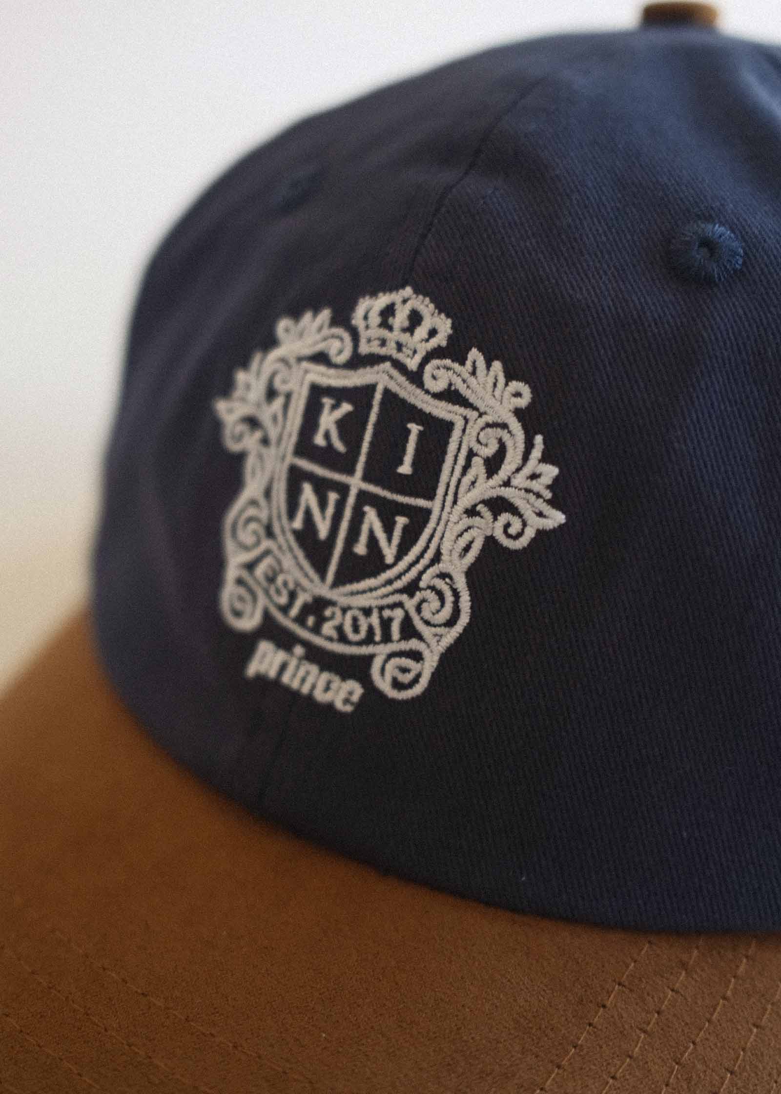close up of the Kinn x Prince emblem embroidered onto the Kinn x Prince The Court Cap