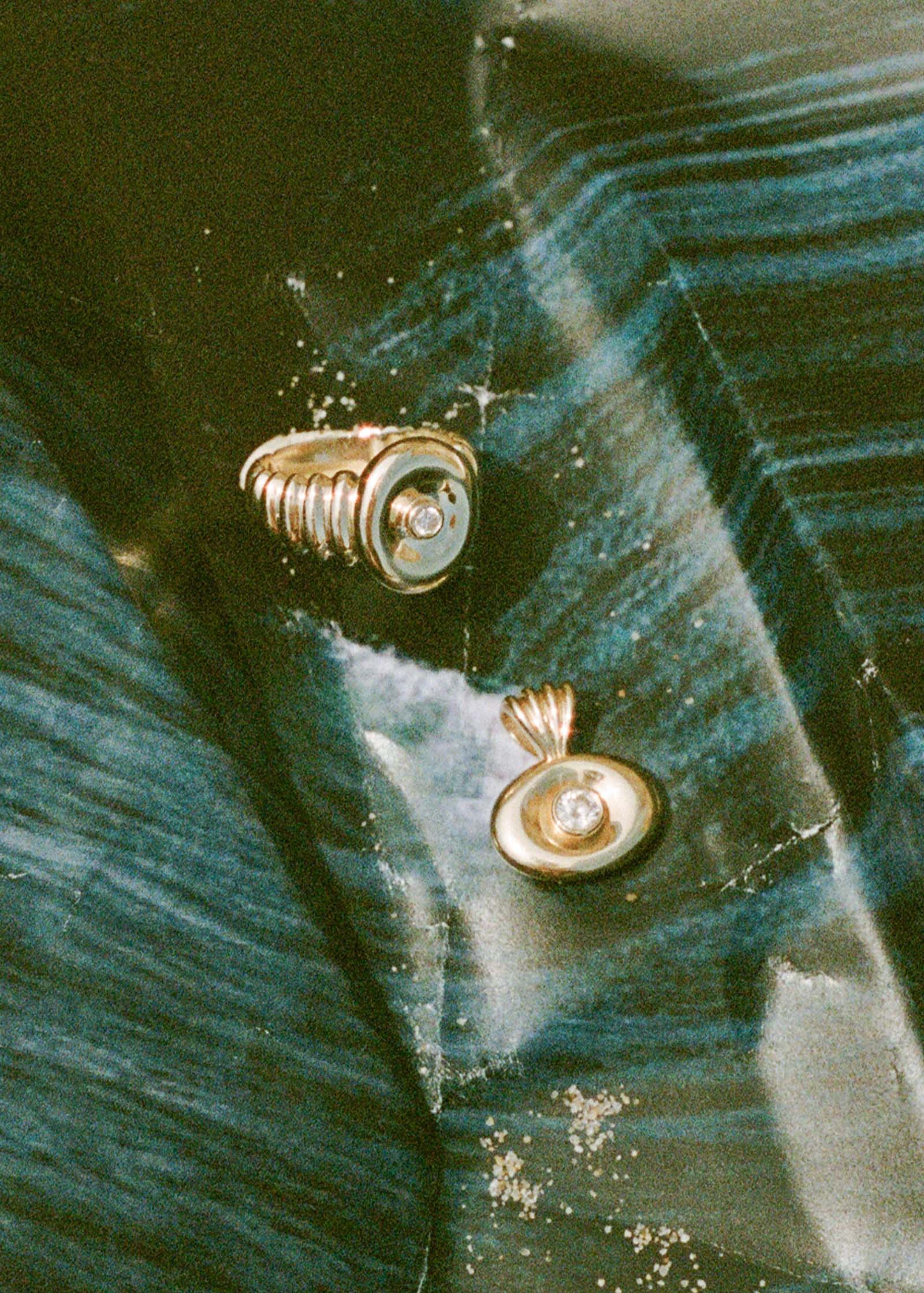a Kinn 14k Gold San Raphael Pendant Diamond laying next to a Osla Diamond Signet Ring 