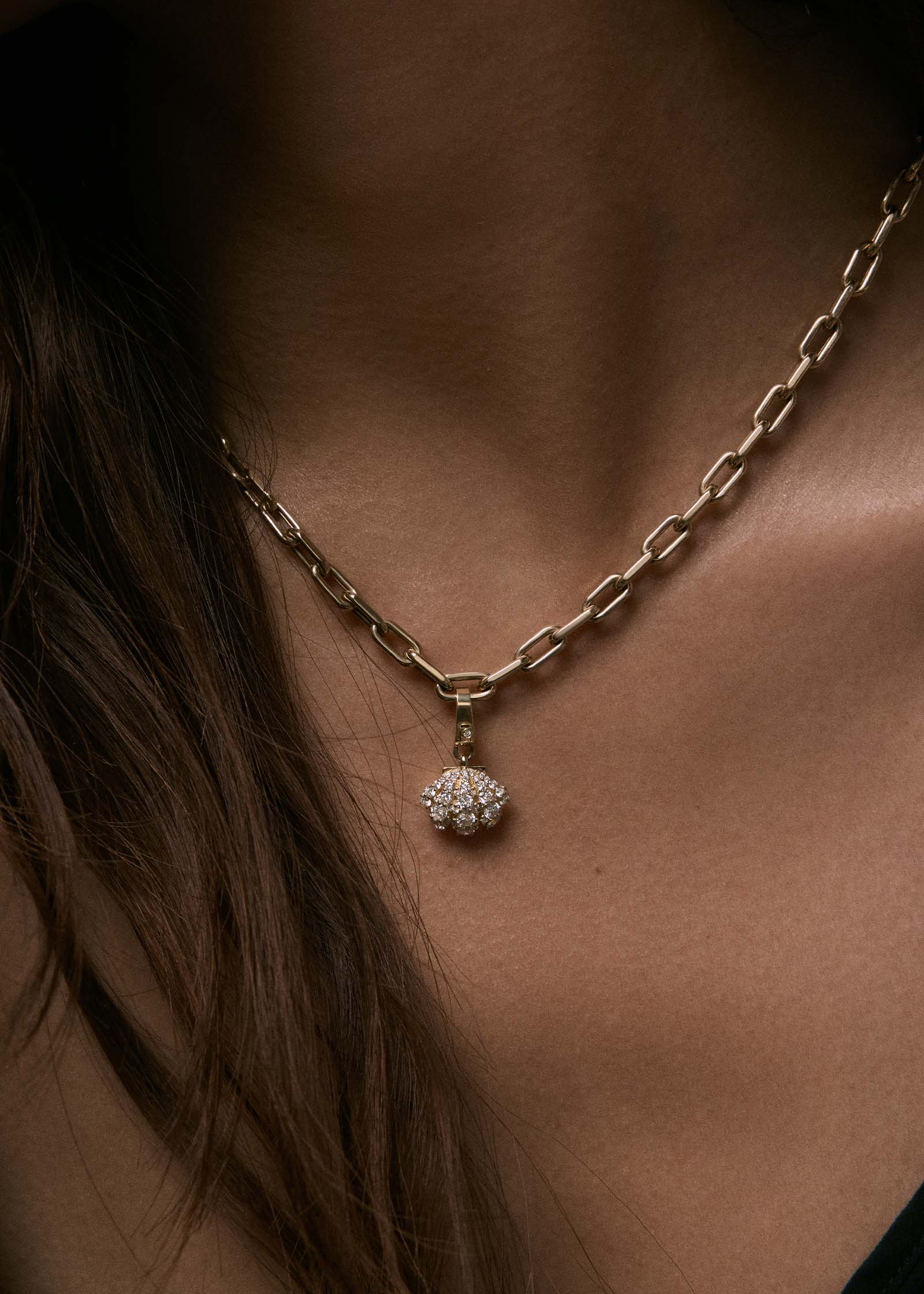 woman wearing a Kinn 14k Gold Pavé Diamond Shell Charm Necklace on Mia Link Chain