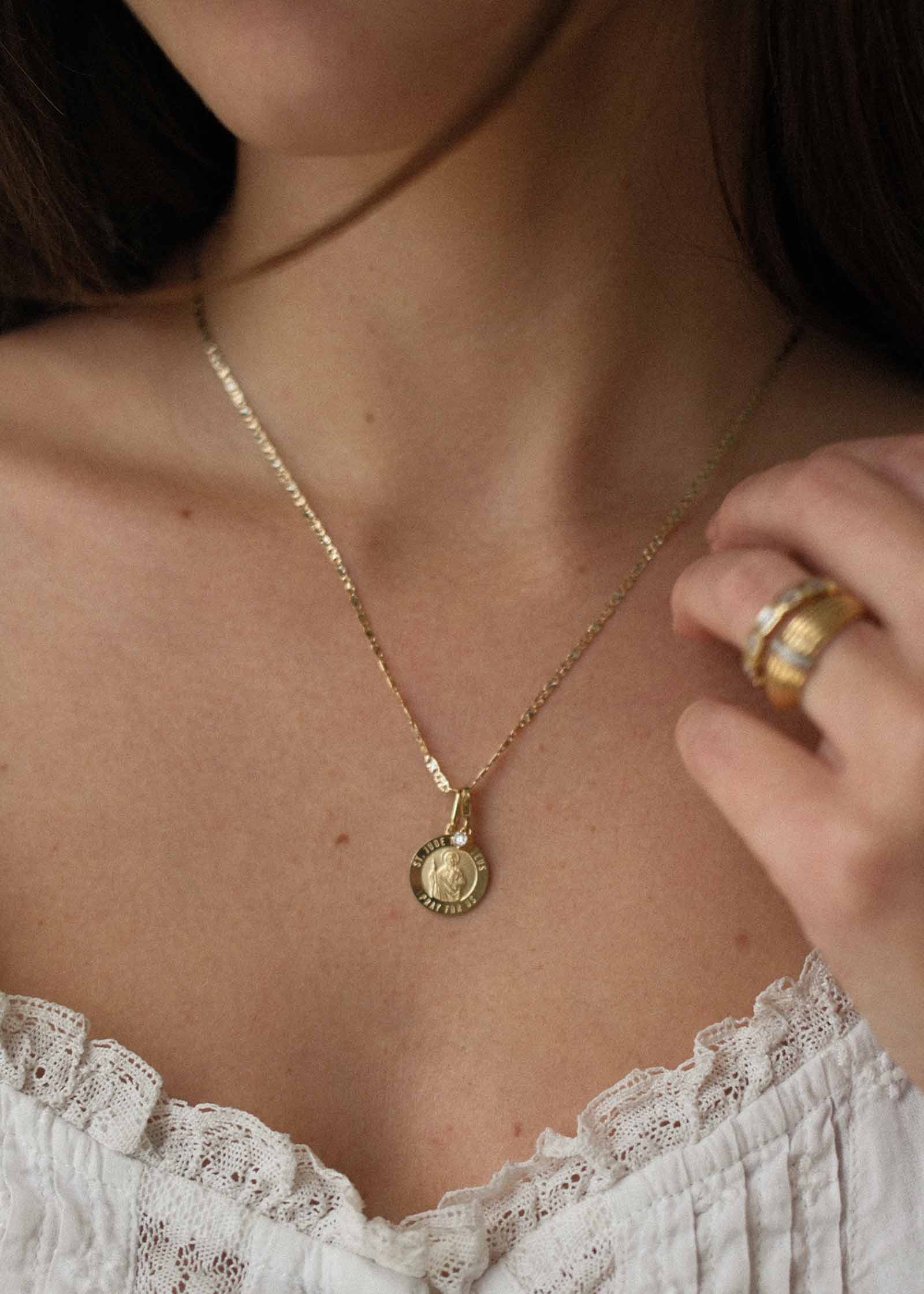 woman wearing a Kinn 14k Gold Saint Jude Charm Pendant on a Valentino Tri Color Chain