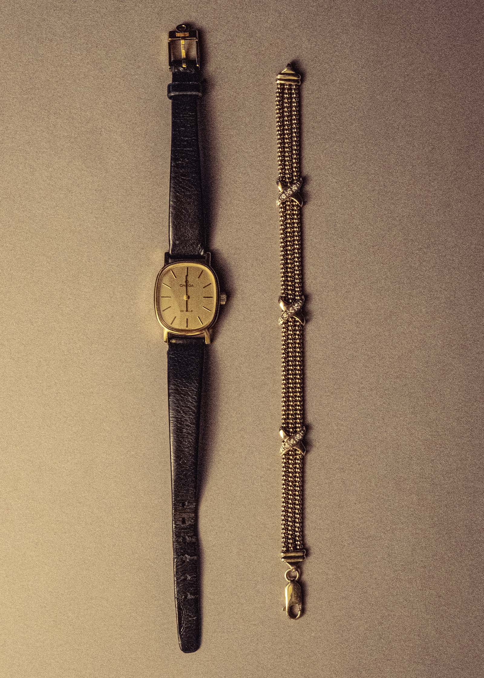 Kinn Vintage 14k Gold Chain Bracelet laying flat next to a vintage omega watch