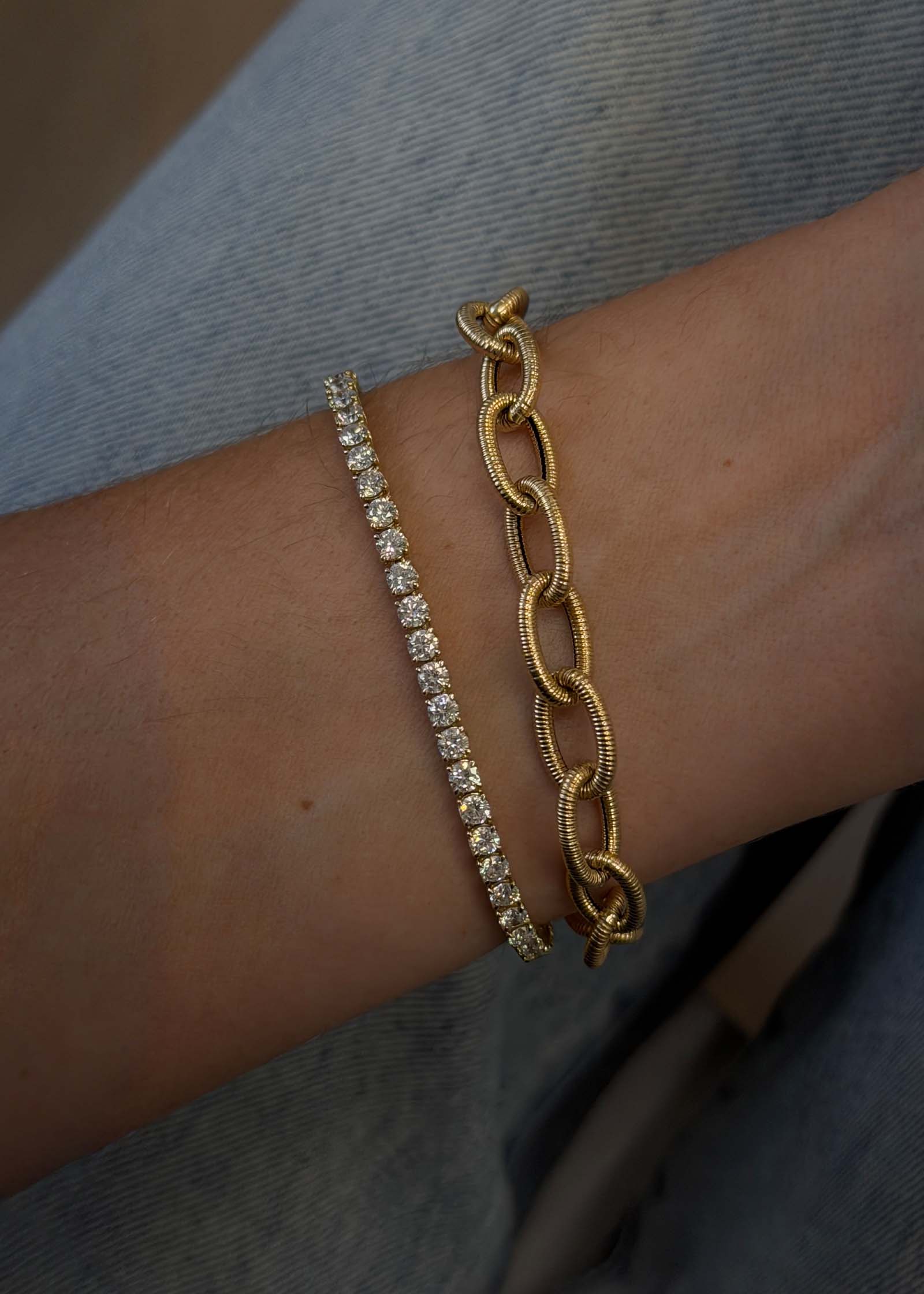 Kinn Vintage 14k Gold Link Chain Bracelet on a wrist stacked with a diamond tennis bracelet