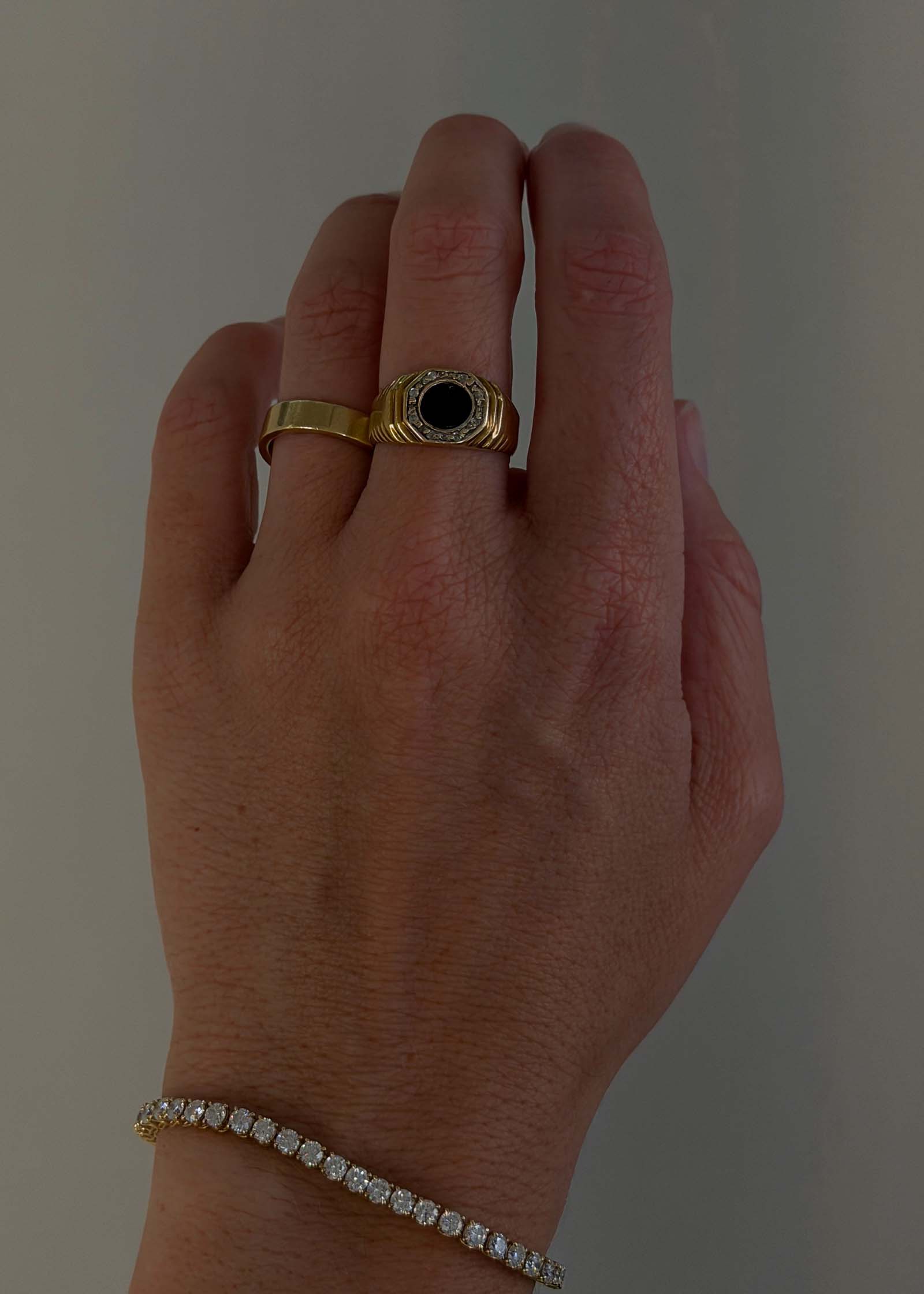 woman's hand wearing a Kinn Vintage 14k Gold Octagon Ribbed Onyx Ring