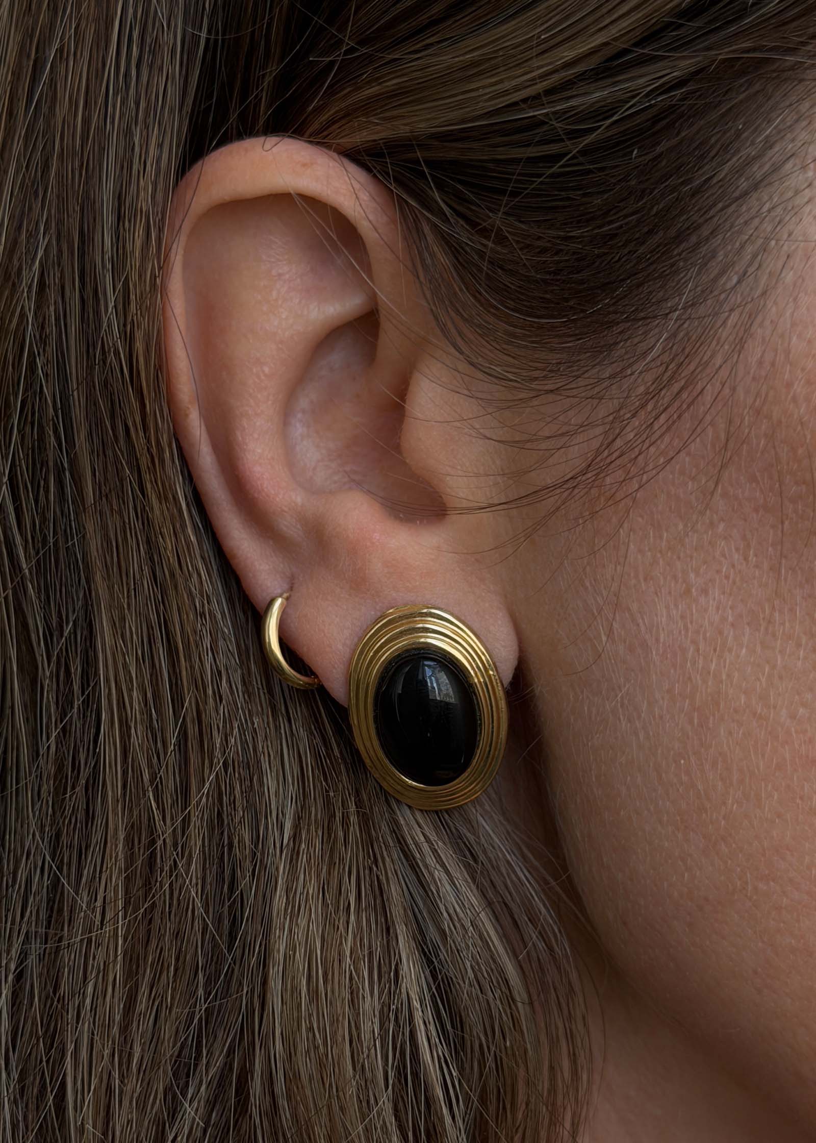 woman wearing a Kinn Vintage 14k Gold Oval Onyx Earrings
