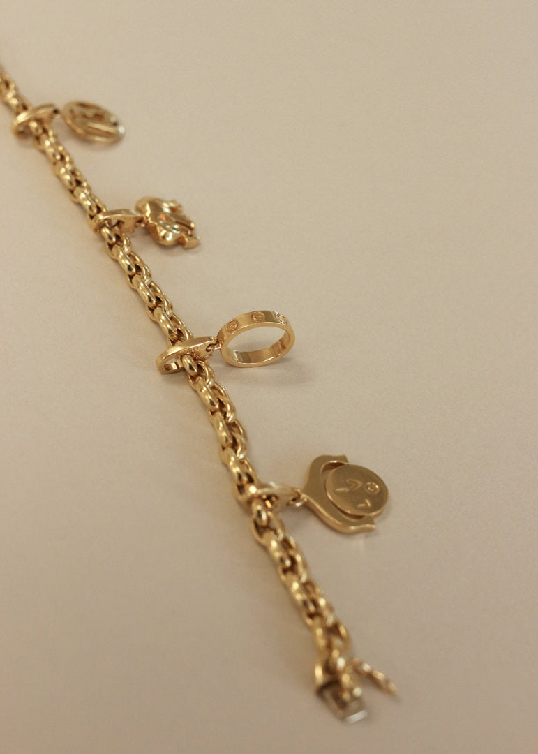 Kinn Vintage 18k Gold Cartier Charm Bracelet laid flat across