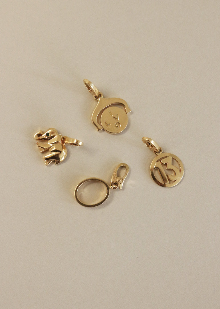 Four vintage 18k gold Cartier charms