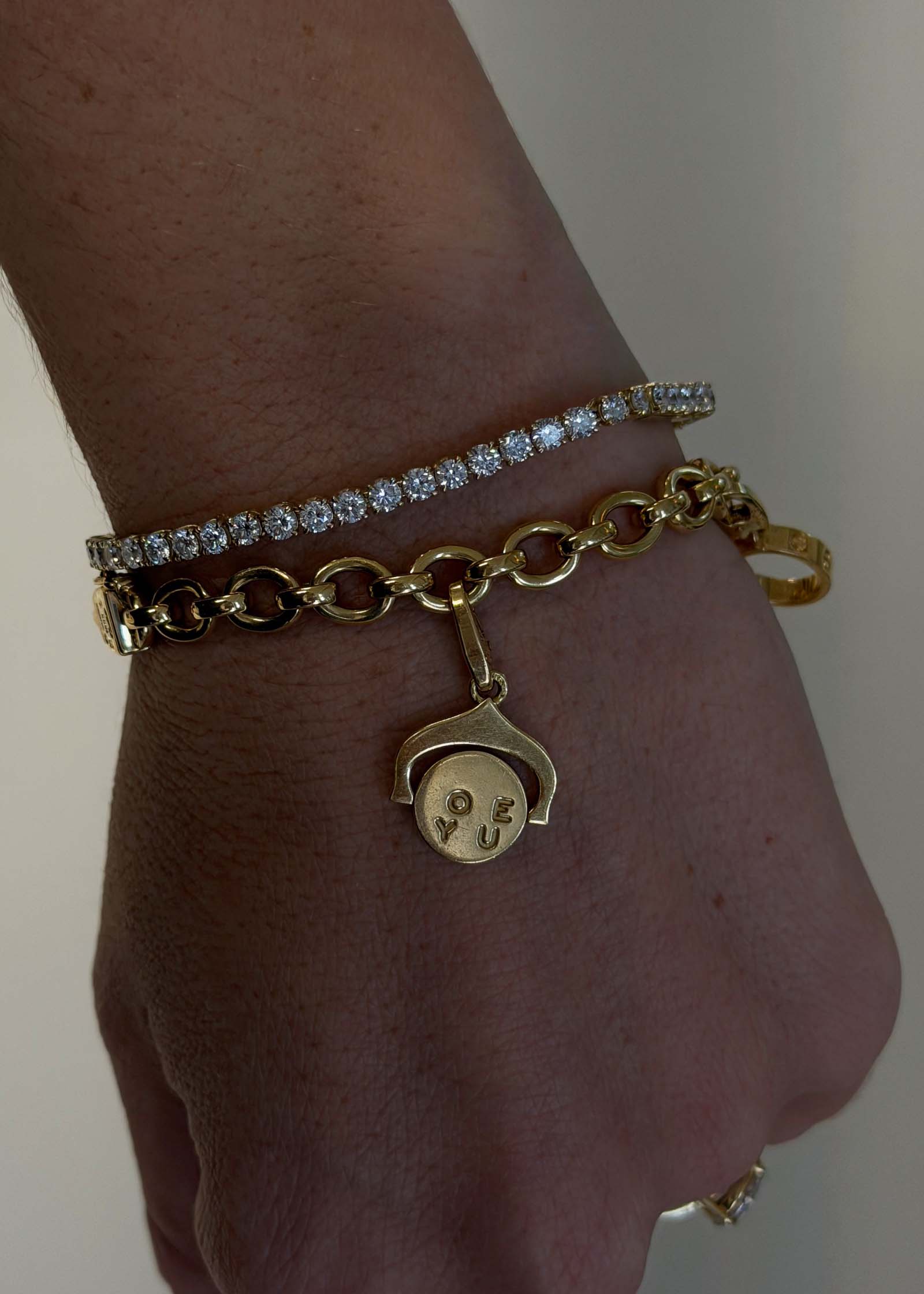 Kinn Vintage 18k Gold Cartier Charm Bracelet being worn showing the "I love you" spinning charm