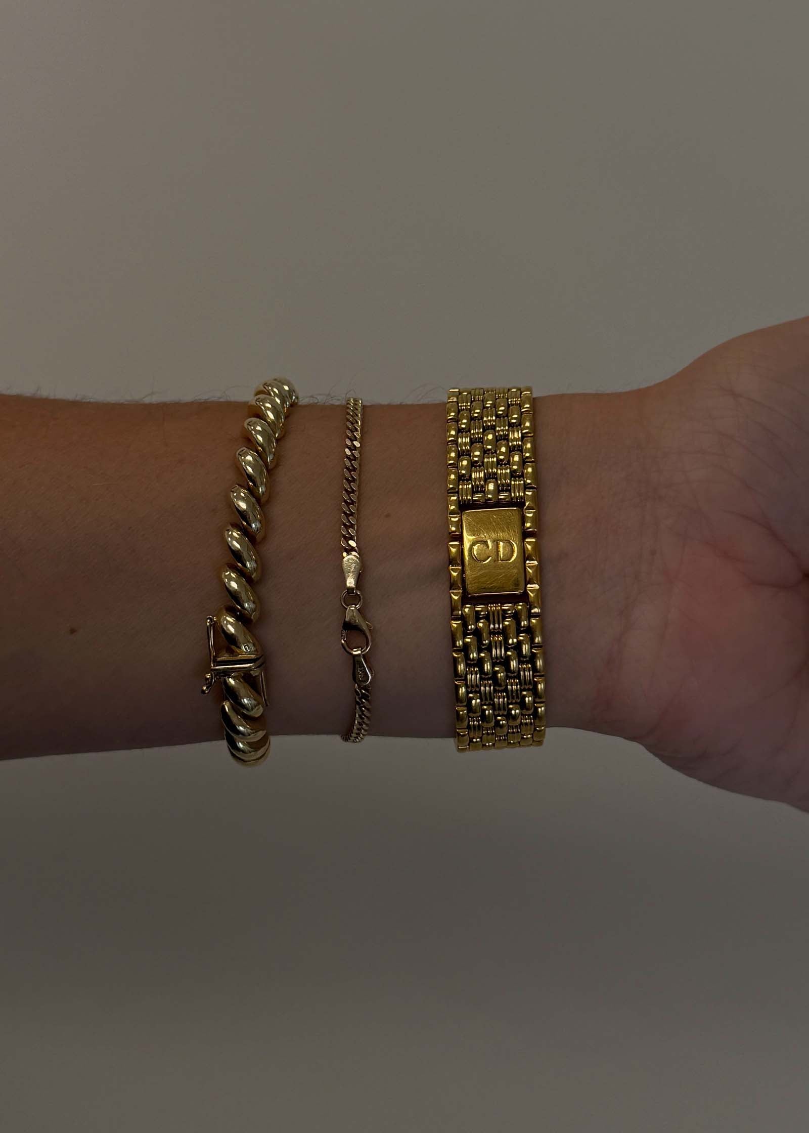 Wrist wearing a Kinn Vintage Christian Dior Gold Watch showing the clasp