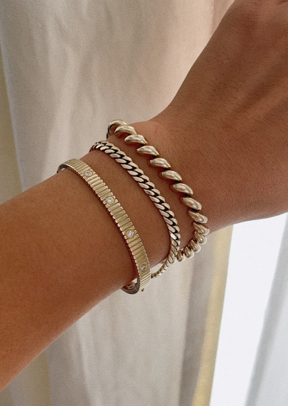 alt="Solis Ribbed IV Anniversary Bracelet with familia cuban bracelet and hampshire house bracelet"