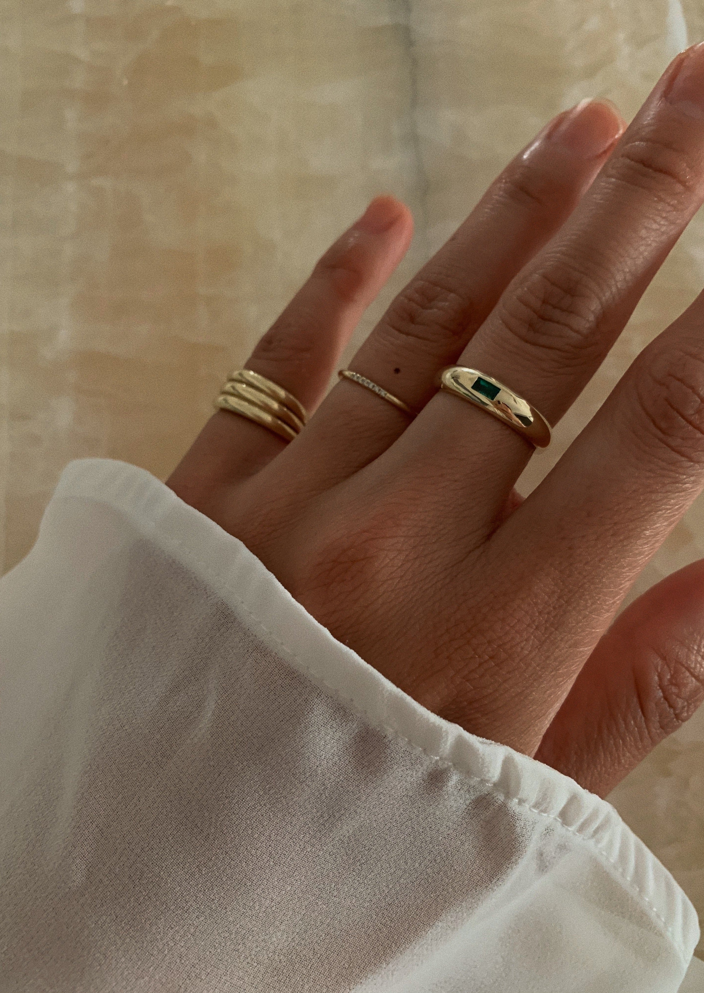 alt="Amelia Dome Ring III - Emerald styled with the francoise stacked ellipse ring I and the VII line ring"