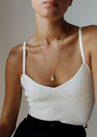 alt="Box Chain Necklace with a Maison oval locket I and kyle figaro necklace"