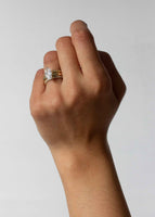 alt="The Daphne styled with the Claudine Twist Ring I and Dahlia III"