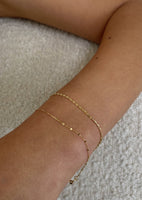 alt="Diamond Cut Rolo Chain Bracelet styled with mariner chain bracelet"