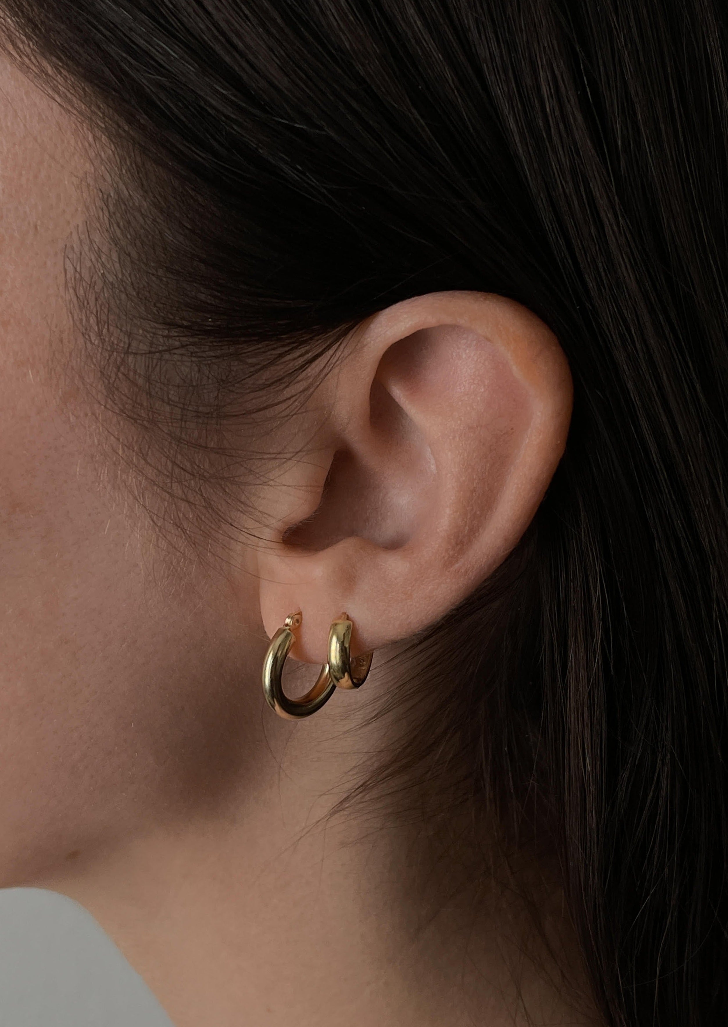 alt="Classic Hoop Earrings - Extra Small styled with mini hoop huggie earring"