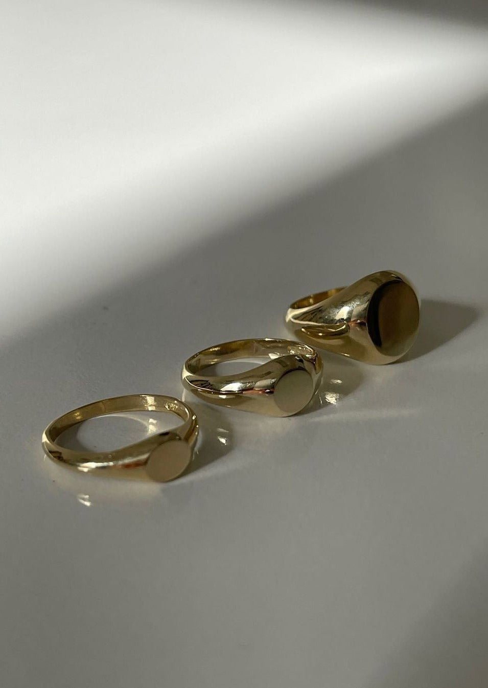 alt="classic signet ring next to medium signet ring and petite signet ring"
